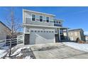 Two-story house with gray siding, stone accents, and a two-car garage at 3734 Makley Cir, Castle Rock, CO 80104