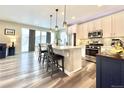 Bright and modern kitchen with stainless steel appliances, white cabinets, granite countertops, island and pendant lighting at 3734 Makley Cir, Castle Rock, CO 80104