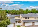 Aerial view of townhouse with stone accents, new gray roof, and attached two-car garage at 2650 S Vaughn Way # B, Aurora, CO 80014