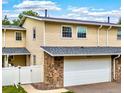 Charming townhouse features stone accents, a two-car garage, and well-maintained siding at 2650 S Vaughn Way # B, Aurora, CO 80014