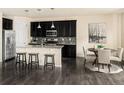 Eat in kitchen with dark cabinetry, stainless steel appliances, granite counters and pendant lighting at 10465 Evansville Cir, Parker, CO 80134