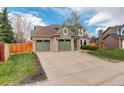 Charming two-story home with three car garage, lush lawn, and well-maintained landscaping at 10059 Granite Hill Dr, Parker, CO 80134