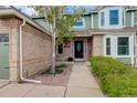 Welcoming front entrance features a stylish door, manicured shrubs, and a paved walkway to the house at 10059 Granite Hill Dr, Parker, CO 80134