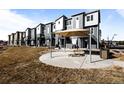 Community patio area with shade structure, table and seating for outdoor gatherings at 2676 W 68Th Ave, Denver, CO 80221