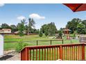 Scenic view from the back deck of the community park, with green grass, a playground, and mature trees at 8721 W 86Th Ave, Arvada, CO 80005