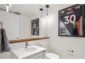 Modern bathroom features a floating vanity, large mirror and football decor at 1750 Wewatta St # 627, Denver, CO 80202