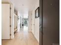 Bright hallway with hardwood floors, storage cabinets and modern fixtures for comfortable living at 1750 Wewatta St # 627, Denver, CO 80202