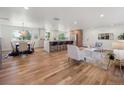 Bright, open-concept living room flowing into a modern kitchen with light wood floors at 11569 W 27Th Ave, Lakewood, CO 80215