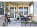 Inviting front porch with comfortable seating, decorative accents, and a cozy atmosphere perfect for relaxing at 7824 S Zante Ct, Aurora, CO 80016