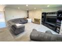 Spacious living room with a fireplace, gray carpet, and a comfortable sectional sofa at 5677 S Lowell Blvd, Littleton, CO 80123
