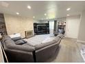 Cozy living room featuring a fireplace, neutral carpet, and a comfortable seating area at 5677 S Lowell Blvd, Littleton, CO 80123