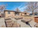 Spacious backyard featuring garden beds, offering plenty of space for outdoor activities at 2045 Jamaica St, Aurora, CO 80010