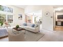 Open-concept living room with a view of the dining area and a large bright window at 1566 S Syracuse St, Denver, CO 80231