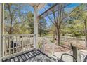 Spacious backyard with a white fence, lawn area, mature trees, and view from covered porch at 2428 Concord Cir, Lafayette, CO 80026