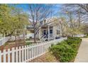 Charming exterior elevation with a white picket fence, garden, and inviting front porch at 2428 Concord Cir, Lafayette, CO 80026