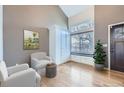 Bright living room with a tall window, hardwood floors, and comfortable seating at 19357 E 40Th Ave, Denver, CO 80249