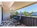 Cozy balcony with seating offers a relaxing outdoor space and views of the neighborhood at 2301 E Fremont Ave # W08, Centennial, CO 80122