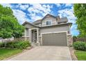 Charming two-story home featuring a well-manicured lawn, neutral siding and a convenient two-car garage at 5778 S Duquesne Ct, Aurora, CO 80016
