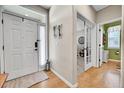 Bright foyer with hardwood floors, white trim, decorative wall hangings and entry to the office at 5778 S Duquesne Ct, Aurora, CO 80016
