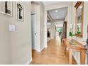 Inviting hallway with hardwood floors, neutral walls, and tasteful decorations and entryway to other rooms at 5778 S Duquesne Ct, Aurora, CO 80016