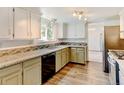 A spacious kitchen with granite countertops, stainless appliances and two-tone cabinets at 1487 S Zeno Way, Aurora, CO 80017