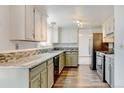 A spacious kitchen with granite countertops, stainless appliances and two-tone cabinets at 1487 S Zeno Way, Aurora, CO 80017