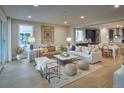 Bright, open-concept living room featuring hardwood floors and modern furnishings with lots of natural light at 4145 N Duquesne Ct, Aurora, CO 80019