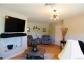 Comfortable living room features hardwood floors, fireplace, and a modern light fixture at 3825 S Monaco Pkwy # 111, Denver, CO 80237