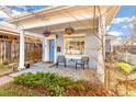 Inviting front porch with hanging baskets and stone flooring at 4508 W 34Th Ave, Denver, CO 80212