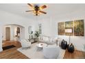 Bright living room with hardwood floors, white walls, stylish decor, ceiling fan and comfortable seating at 4508 W 34Th Ave, Denver, CO 80212