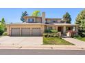 Charming home with a three-car garage, well-kept lawn, and inviting front entrance at 4800 E Cedar Ave, Denver, CO 80246