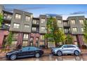 Modern condo complex with brick and siding, balconies, and convenient street parking at 7700 E 29Th Ave # 405, Denver, CO 80238