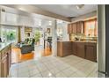 A spacious kitchen flows into a living area, with tiled floors and abundant natural light at 7101 Alan Dr, Denver, CO 80221