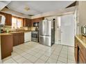 Features stainless steel appliances, tile flooring, and granite countertops for a sleek, modern look at 7101 Alan Dr, Denver, CO 80221
