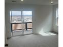 Light-filled bedroom with sliding door to a private outdoor balcony at 8858 Waterleaf Ln, Littleton, CO 80125