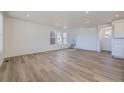 Bright, open living room with hardwood floors and recessed lighting at 8858 Waterleaf Ln, Littleton, CO 80125