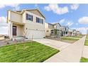 A street view featuring a line of attractive two-story homes with well-kept lawns and driveways at 1638 Plata St, Lochbuie, CO 80603