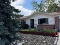 View of a white single Gathering house and a decorative front yard at 1843 S Urban Way, Lakewood, CO 80228