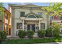 Attractive home with a welcoming entrance, classic columns, and manicured landscaping at 1580 N Franklin St, Denver, CO 80218