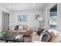 Light and airy living room with two neutral sofas and a coffee table at 2758 W 38Th Ave, Denver, CO 80211