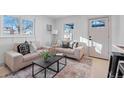 Bright living room featuring neutral colored couches and a coffee table at 2758 W 38Th Ave, Denver, CO 80211