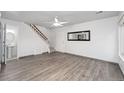 Bright living room showing stairs, bathroom, and entry, illuminated by a modern ceiling fan at 7999 Chase Cir # 31, Arvada, CO 80003