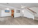 Inviting living room with modern flooring, ceiling fan, adjacent kitchen, and stairway access at 7999 Chase Cir # 31, Arvada, CO 80003