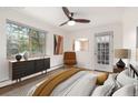 Cozy bedroom features a ceiling fan, an exterior door, and natural light from the windows at 70 N Grant St # 10, Denver, CO 80203