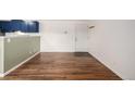 Hardwood floors in an open living space with white walls and blue kitchen cabinets at 70 N Grant St # 10, Denver, CO 80203