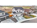 Spacious two-story home with attached three-car garage, complimented by expansive farmland views in the background at 14696 Bonsmara Dr, Mead, CO 80542