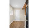The entryway features wood look floors, a white door, and an accent beam at 1264 Uinta St, Denver, CO 80220