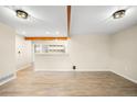 Spacious living room with beautiful wood-look floors and exposed beams at 1264 Uinta St, Denver, CO 80220