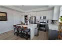 Open kitchen with quartz countertops, stainless steel appliances, island with seating, and pantry at 1295 Utica St, Denver, CO 80204