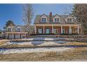 A distinguished residence showcasing a manicured lawn and classic architectural design at 19 Red Fox Ln, Littleton, CO 80127